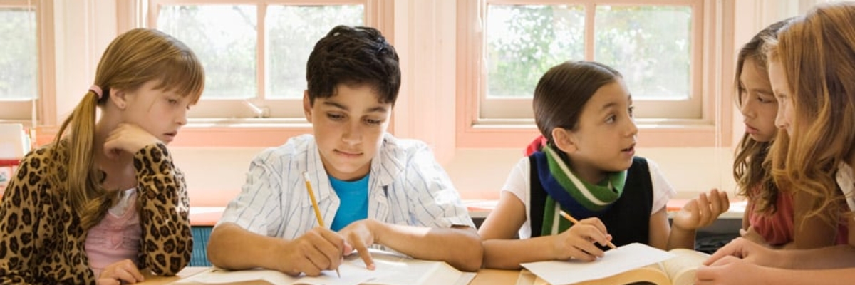 Students working together and reading at school
